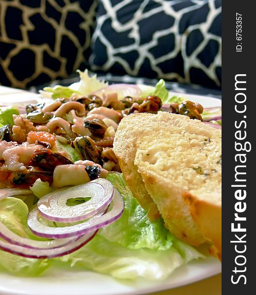 Plate of seafood salat on the table. Close up.