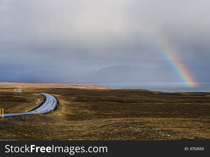 Landscape with rainbow and road in Iceland