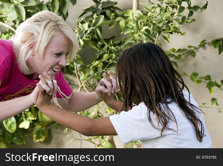 Young boy fighting with blonder woman on natural background. Young boy fighting with blonder woman on natural background