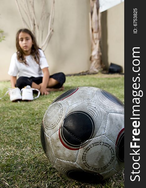 Close Up Of Football And Boy Sitting On Background