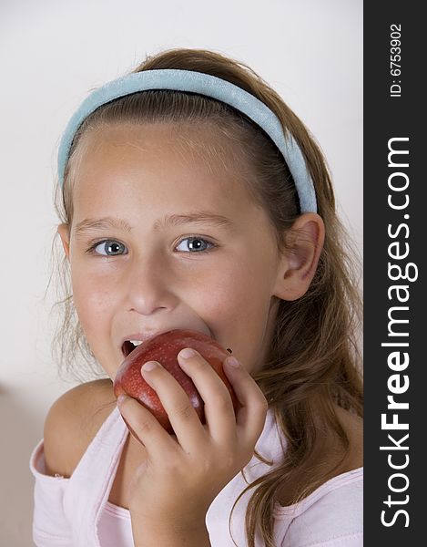 A little girl eating apple