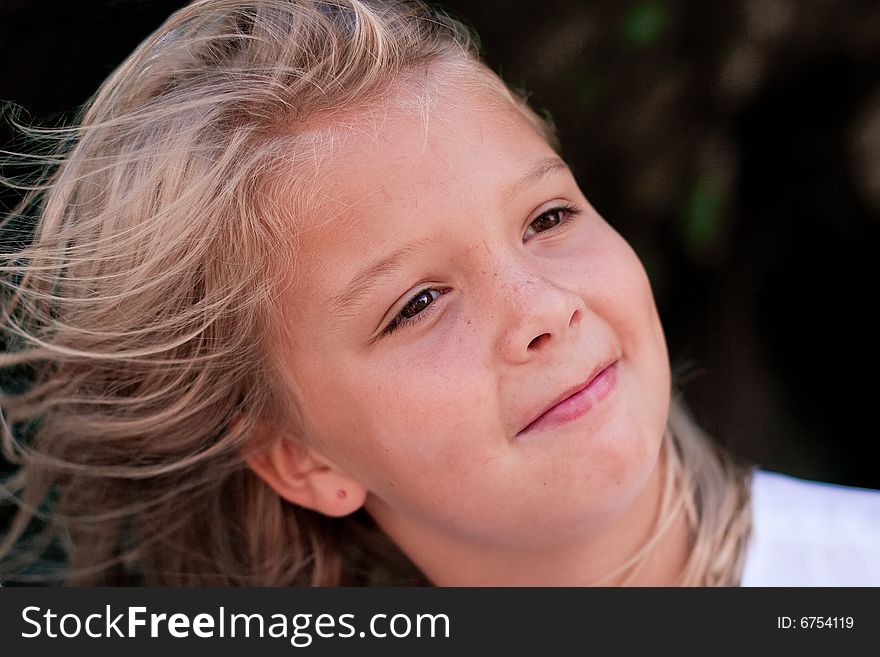 Beautiful little girl with hair blowing in the wind. Beautiful little girl with hair blowing in the wind