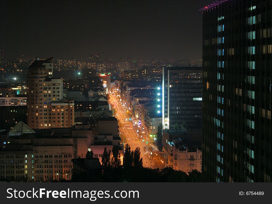 Brightly lit street in night city, Kyiv