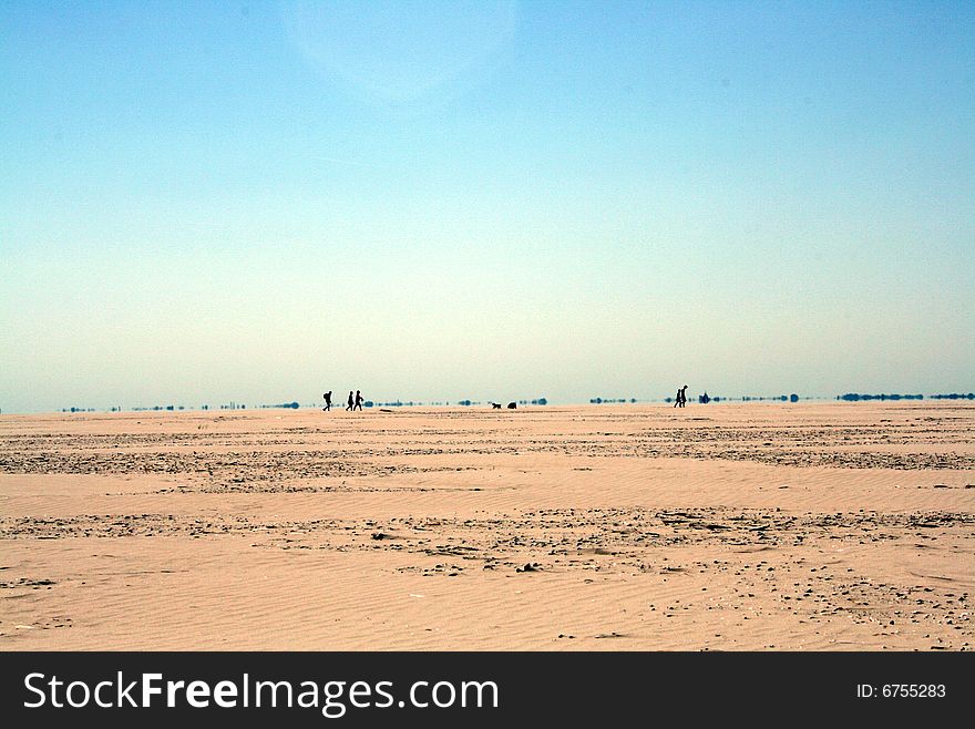 Desert with silhouettes of people on the horizon. Desert with silhouettes of people on the horizon