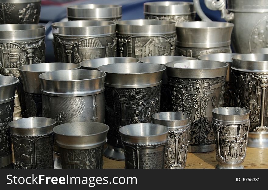 Antique metal cups in a market. Antique metal cups in a market.