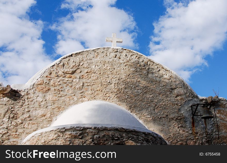 View of an old christian church in Cyprus against a blue cloudy sky. View of an old christian church in Cyprus against a blue cloudy sky