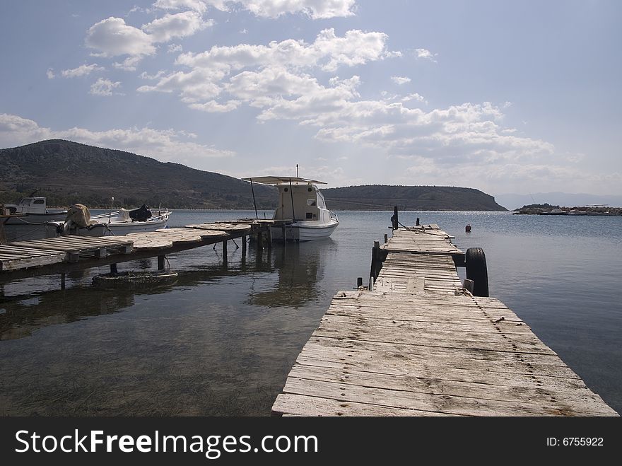 Boat at a wooden dock. Boat at a wooden dock