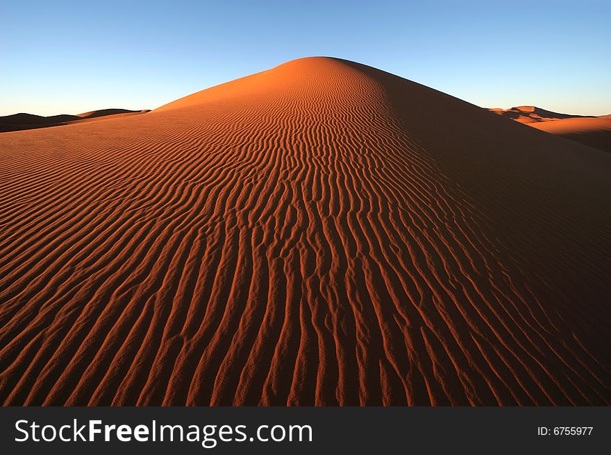 Morning light on the dune surface. Morocco. Morning light on the dune surface. Morocco.