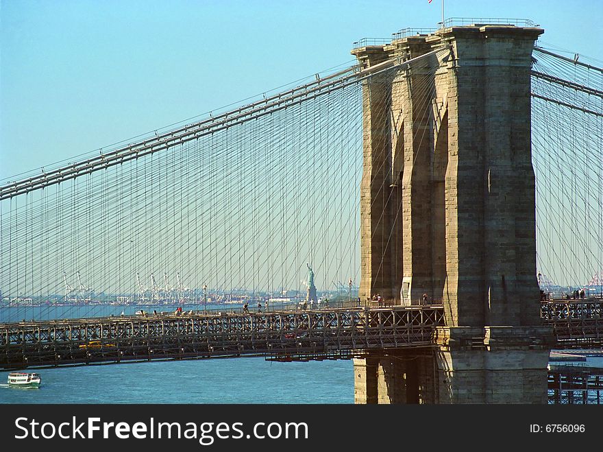 Statue of Liberty and Brooklyn Bridge bask in autumn sun. Statue of Liberty and Brooklyn Bridge bask in autumn sun.