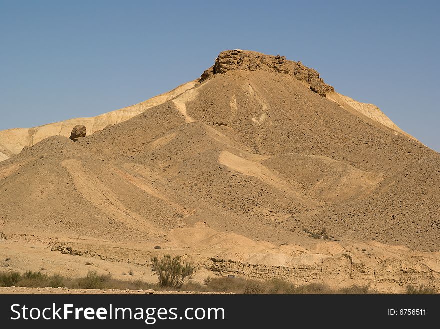 Rock and colored terrain in Big Crater, Negev desert, Israel.