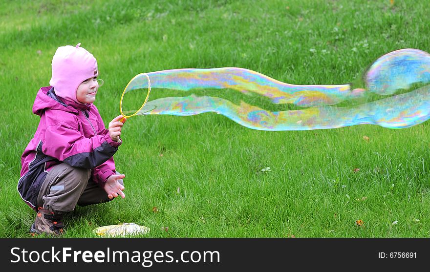 Young girl playing with giant soap bubble. Young girl playing with giant soap bubble