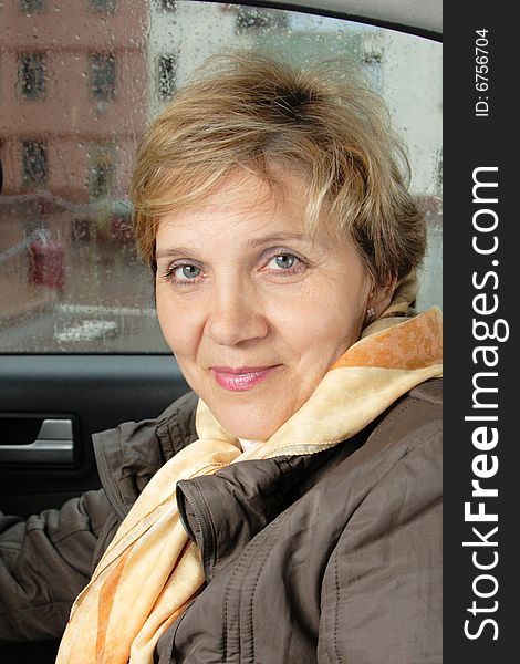 Portrait of attractive senior woman sitting in a car. Portrait of attractive senior woman sitting in a car