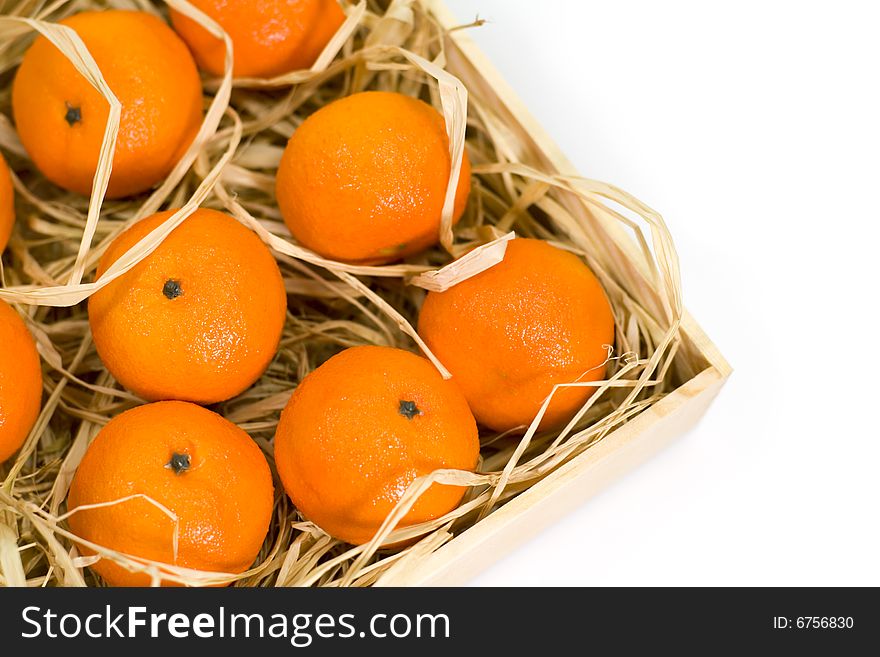 Tangerines with straw in wooden box