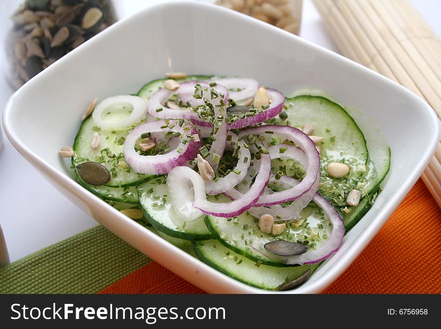 A fresh salad of cucumbers with red onions