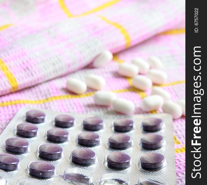 Violet and white tablets on the towel