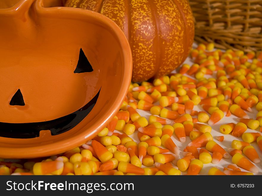 A halloween themed scene with candy corn and jack-o-lanterns. A halloween themed scene with candy corn and jack-o-lanterns