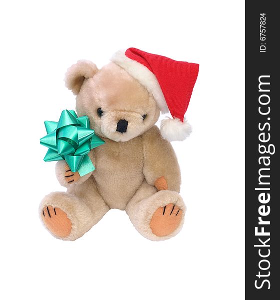 Photograph of a teddy bear with a Father Christmas hat, holding a decorative green bow. White background. Photograph of a teddy bear with a Father Christmas hat, holding a decorative green bow. White background.
