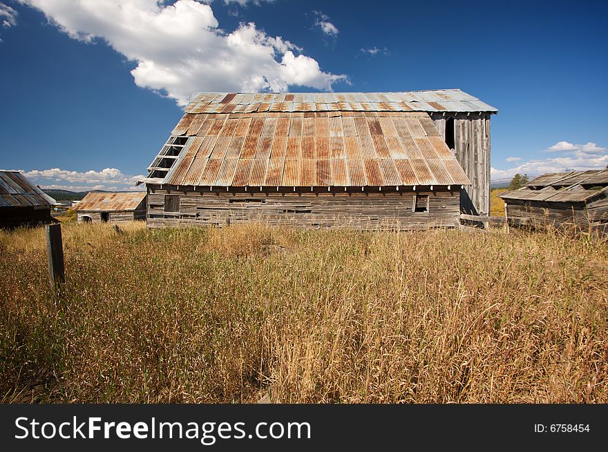 Rustic Barn Scene with Deep Blue Sky and Clouds