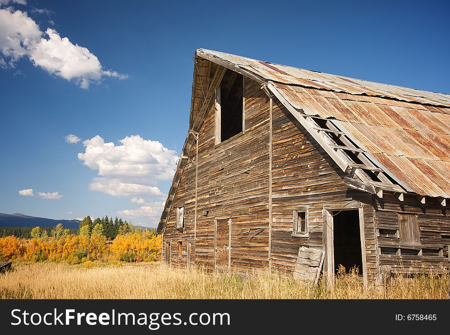 Rustic Barn Scene with Deep Blue Sky and Clouds