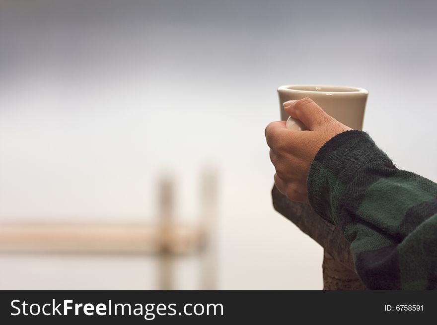 Woman Enjoys Morning Cup Coffee on the Lake. Woman Enjoys Morning Cup Coffee on the Lake.