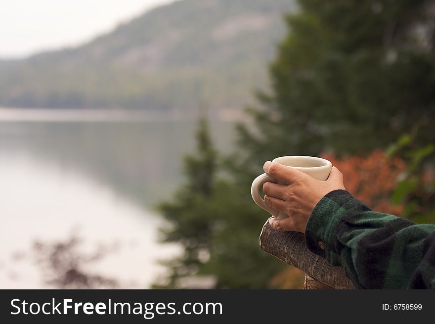 Woman Enjoys Morning Cup Coffee on the Lake. Woman Enjoys Morning Cup Coffee on the Lake.