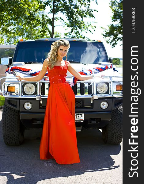 Girl standing with her hands on the hummer. Girl standing with her hands on the hummer