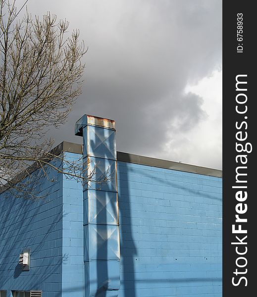 Blue industrial building and dark sky