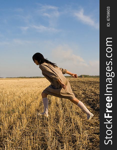 Girl running on the field in sunny day