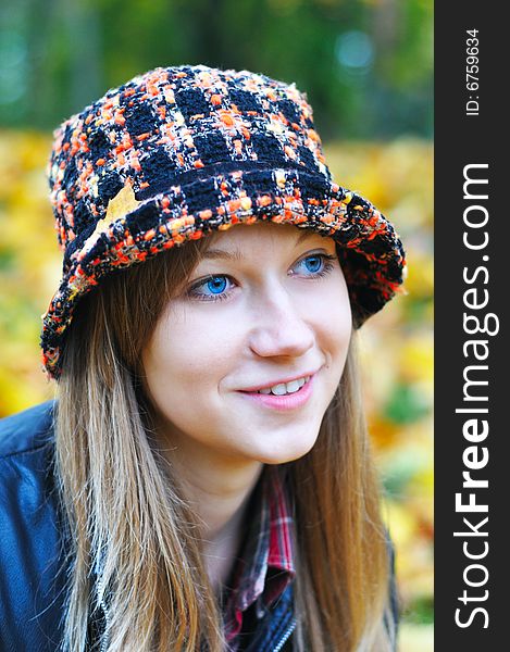 Autumn portrait of the pretty girl in park