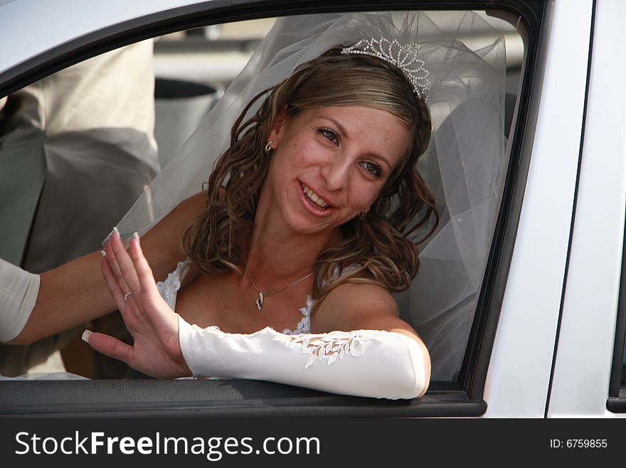 Happy bride in the car