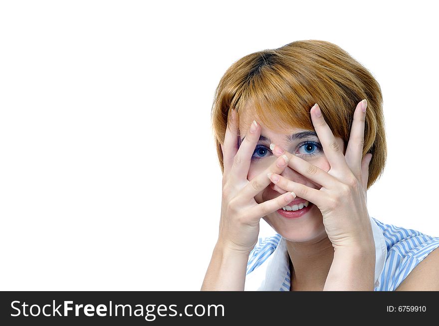 Foxy young smiling woman closes face by hands, isolated on white