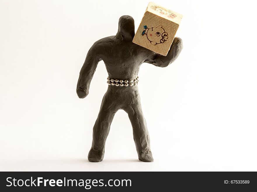 Plasticine man with a wooden cube