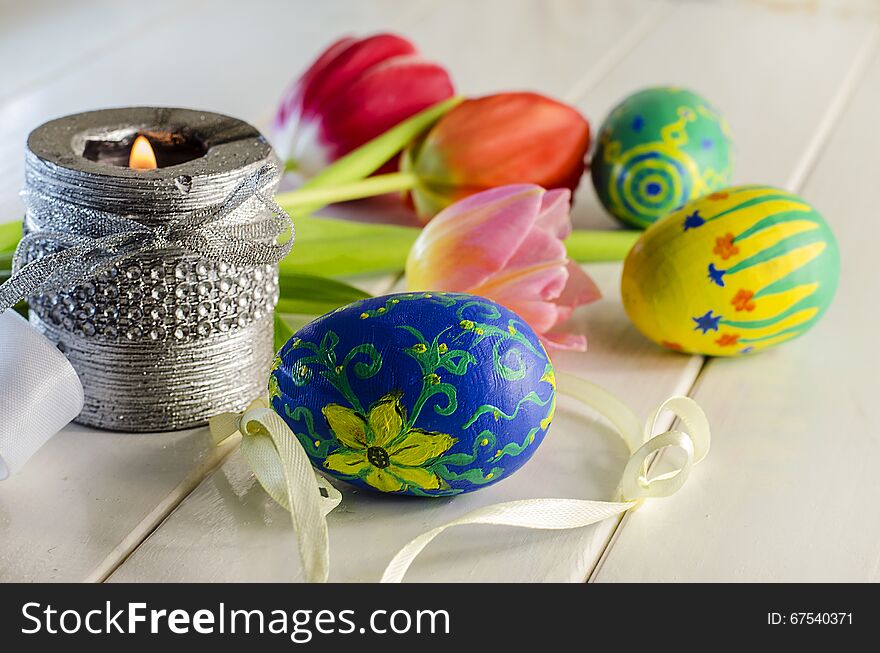 Easter eggs and colorful spring flowers on a white background. Easter eggs and colorful spring flowers on a white background