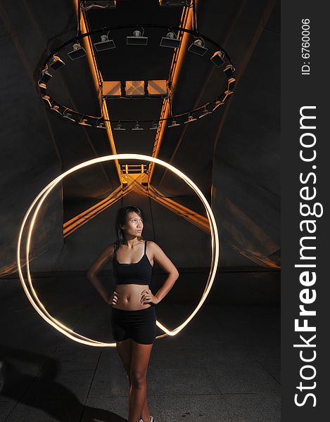 Artistic Picture of an athlete standing under athletic equipment, painted with light. Artistic Picture of an athlete standing under athletic equipment, painted with light.