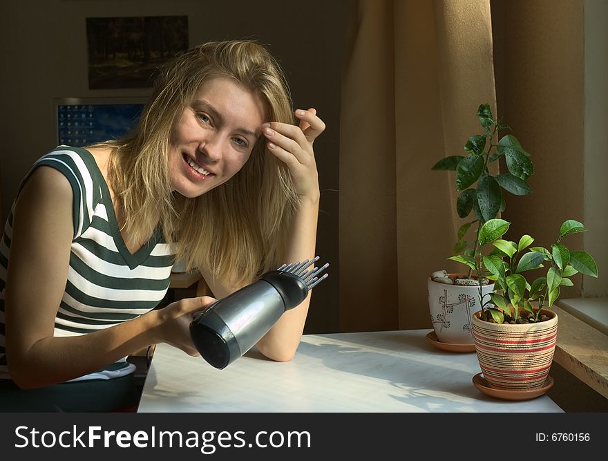 Smiling girl drying her hair. Smiling girl drying her hair