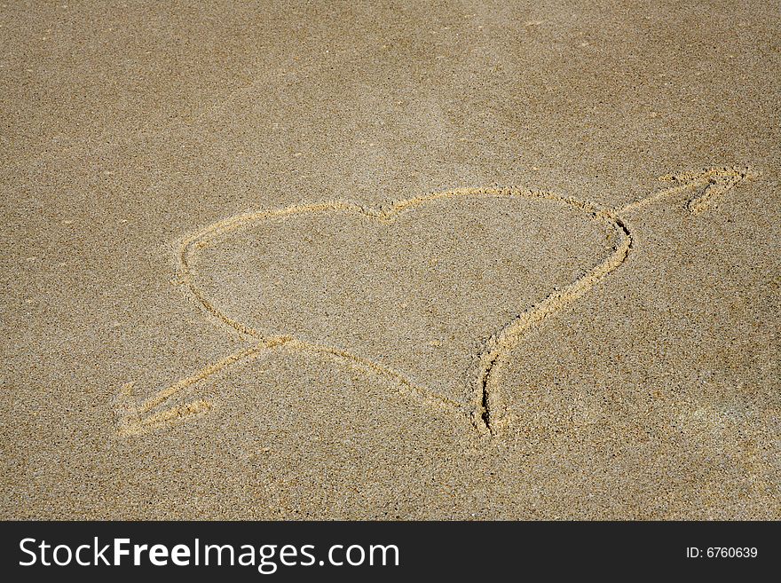 Heart-shaped design in the sand
