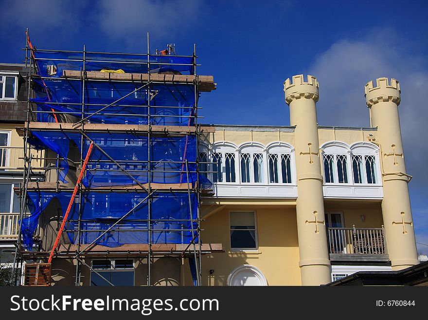 Scaffolding in use on a curious castellated building in Devon