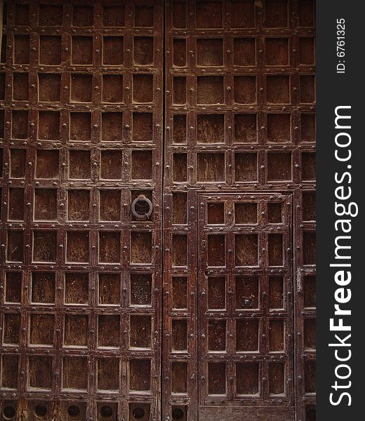 Old brown door with grating decor. Old brown door with grating decor