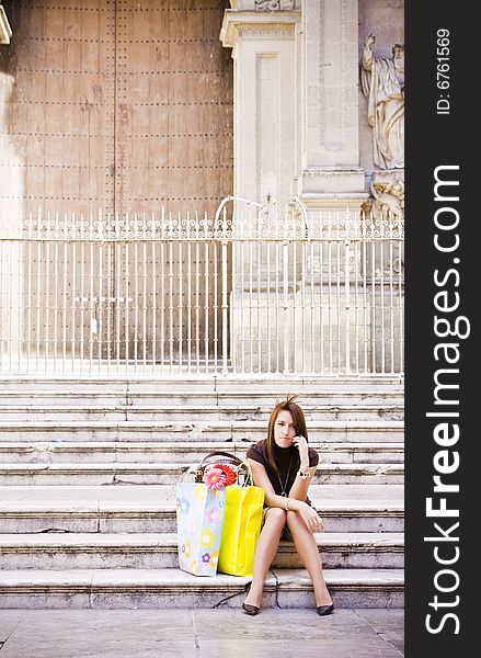 Young woman having a phone chat after shopping. Young woman having a phone chat after shopping.