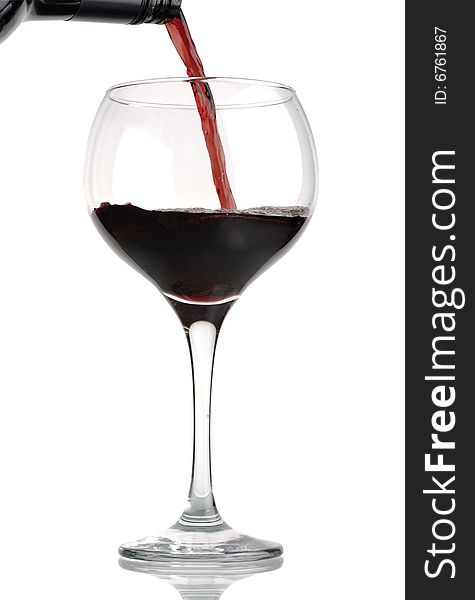 Red wine being poured from bottle into wineglass, isolated against white. Red wine being poured from bottle into wineglass, isolated against white