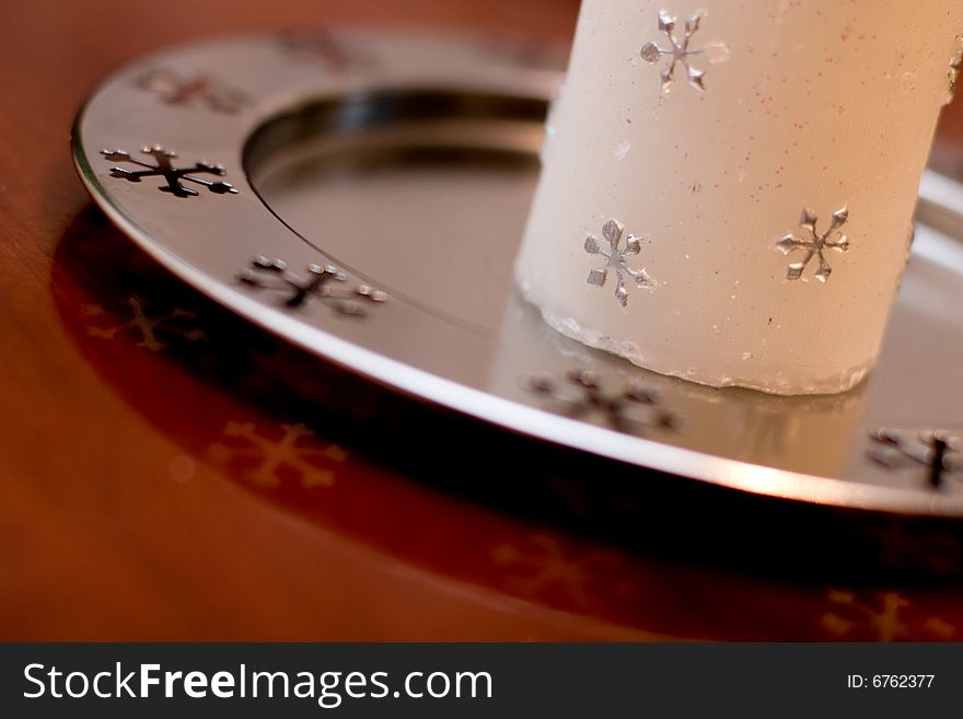 Christmas white candle detail with silver snowflakes