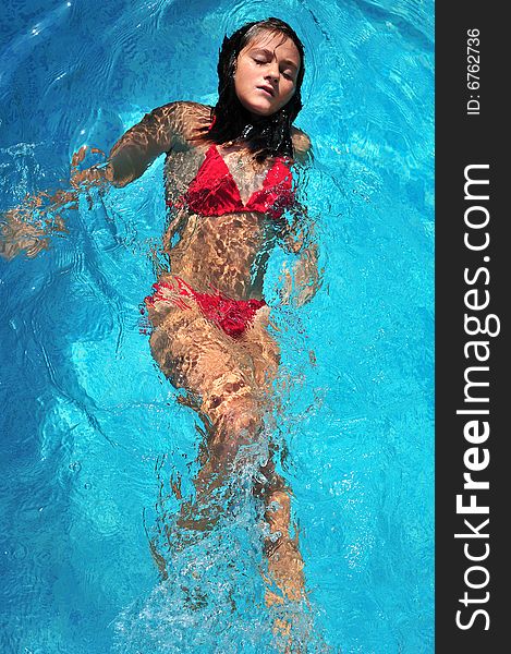 Top view of a girl swimming in pool