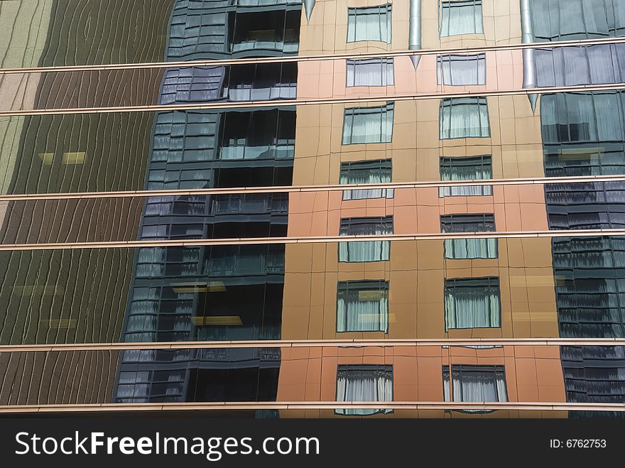 Reflections of nearby buildings in the glass of an office building. Reflections of nearby buildings in the glass of an office building