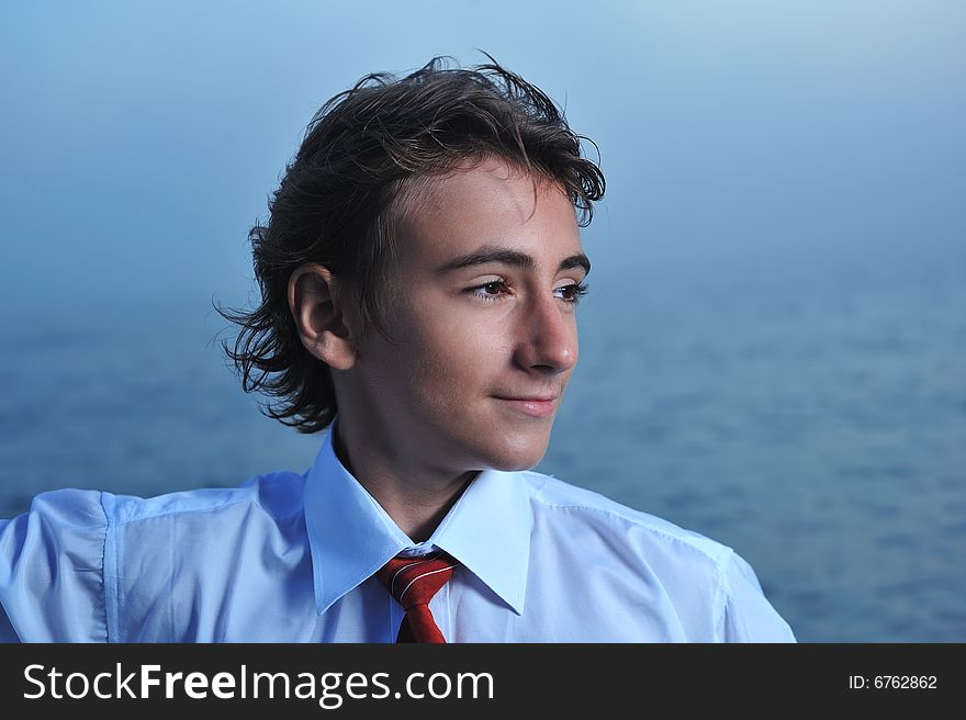 Close up of young businessman standing on sea