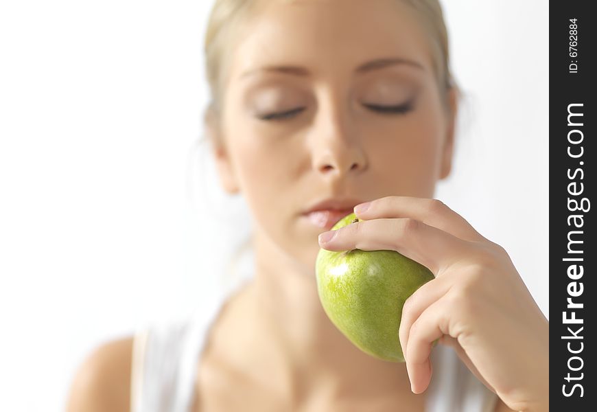 Young, beautiful female eating an apple. Young, beautiful female eating an apple
