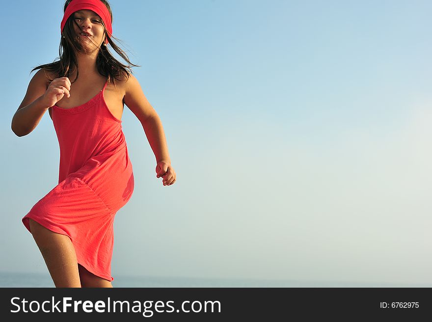 Young girl in red dress dancing in nature. Young girl in red dress dancing in nature