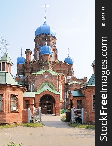 Orthodox church from a red brick with blue domes