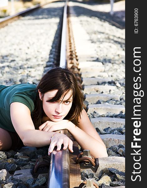 Sad young woman laying on the railway. Sad young woman laying on the railway.