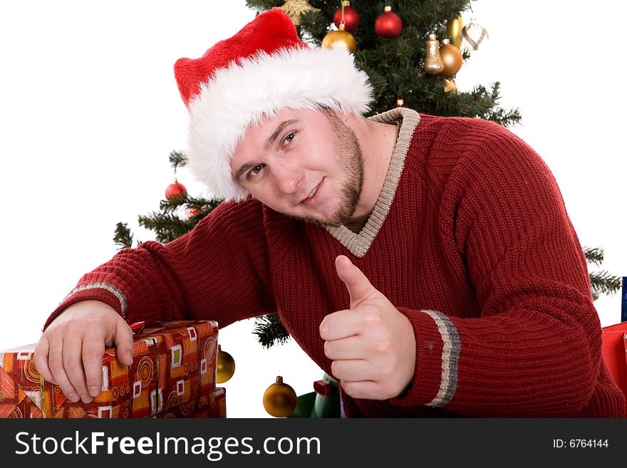 Happy man with gifts over christmas tree. Happy man with gifts over christmas tree