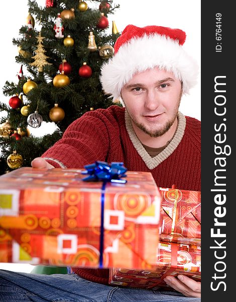 Happy man with gifts over christmas tree. Happy man with gifts over christmas tree